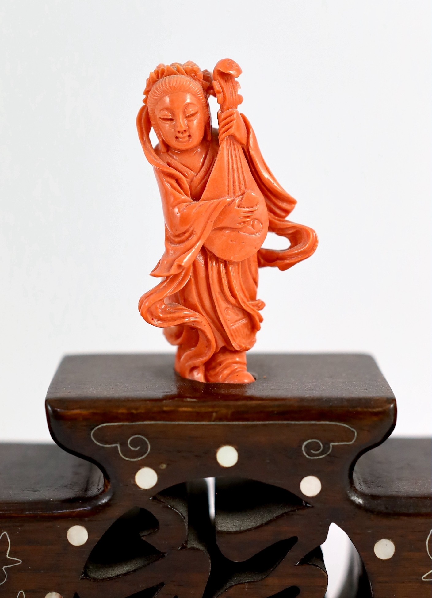 A Chinese or Japanese set of seven coral figures of immortals, 43cm wide, figures 4 to 8cm high